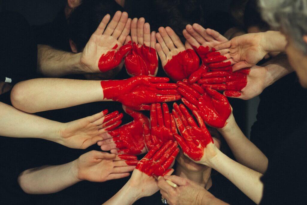 collection of hands painted in red. Emotional intelligence and workplace culture