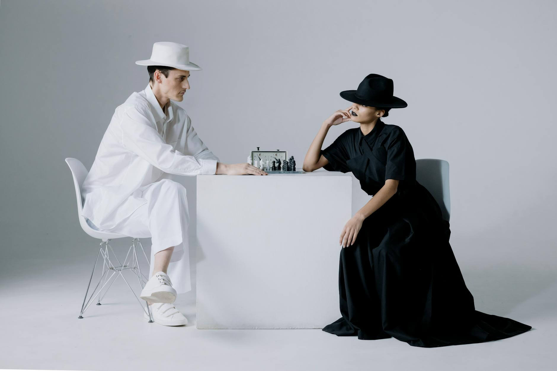 man playing chess with a woman