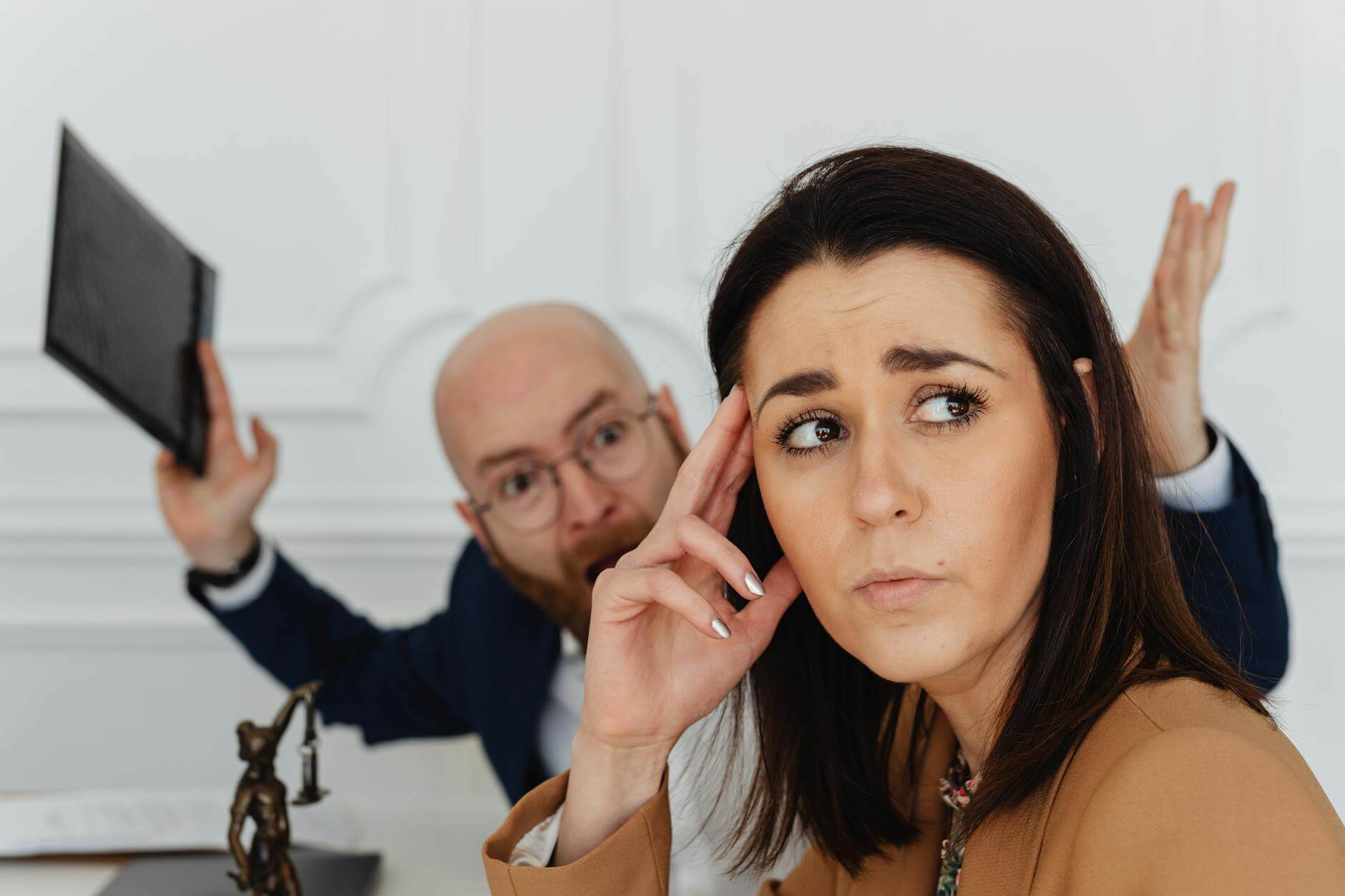 shouting man behind sad woman